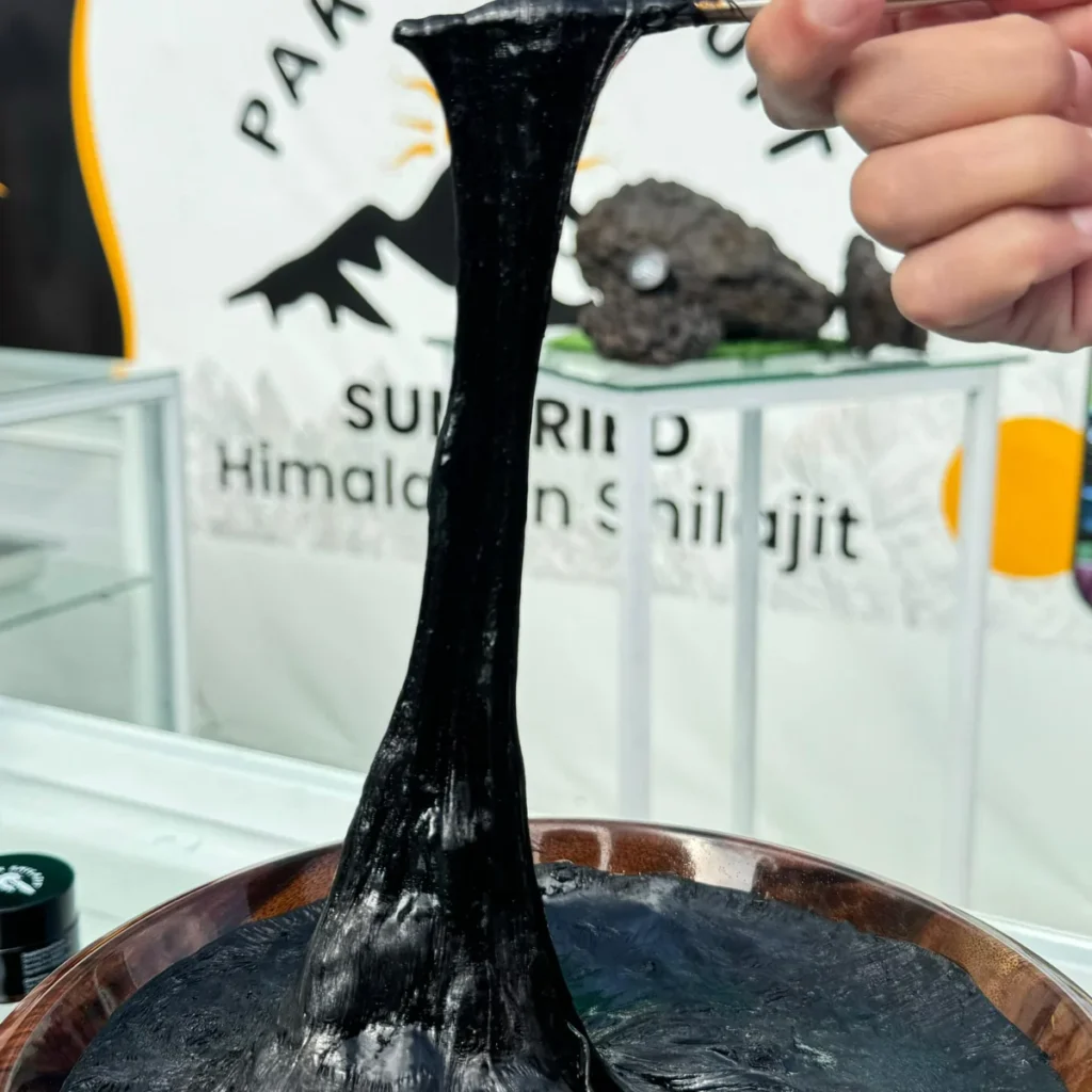 The stretch test on pure shilajit resin, showing the pull of real resin